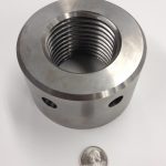 A machined component with an internal acme thread.