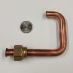 A copper tube CNC bent with a flared end and a nut that gets brazed into an assembly.