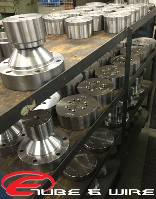 Cart full of machined bearing base components.
