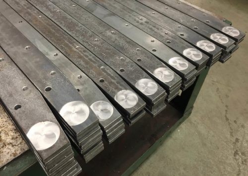 This is a stack of flat bar being machined as preparation to be welded into an assembly.
