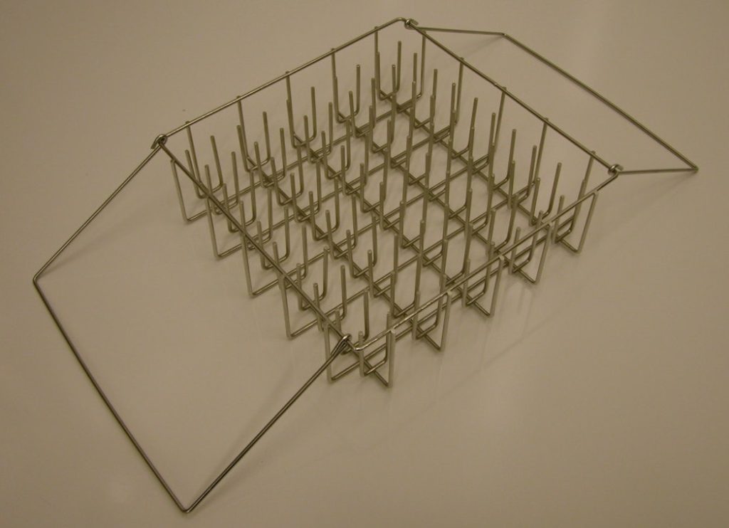 A pin basket that is used to clean test tubes. A test tube is stacked
